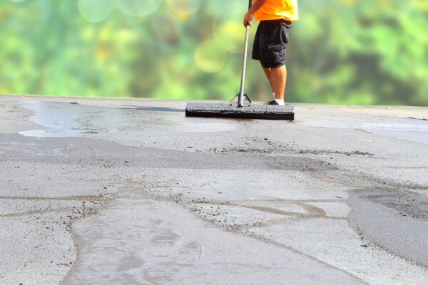 worker repairing parking lot